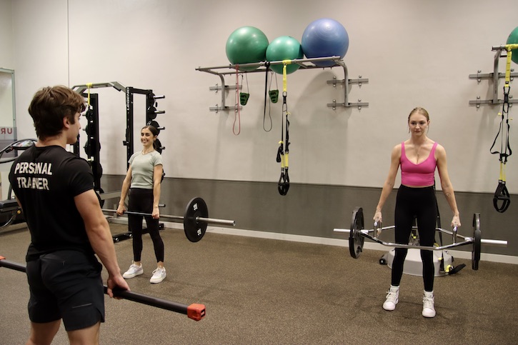 small group training participants lifting weights