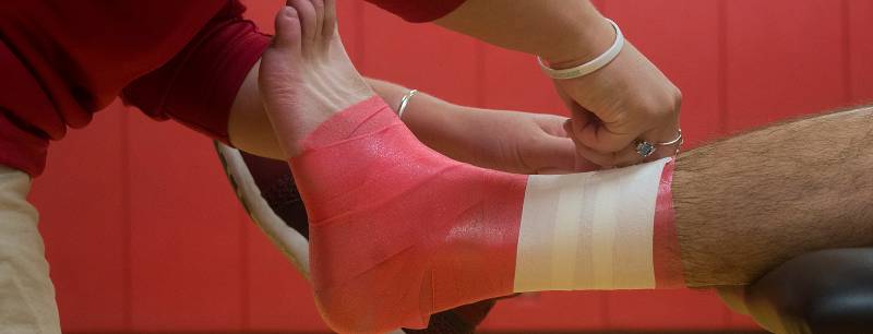 UREC Sports Injury Clinic taped ankle on athletic training table